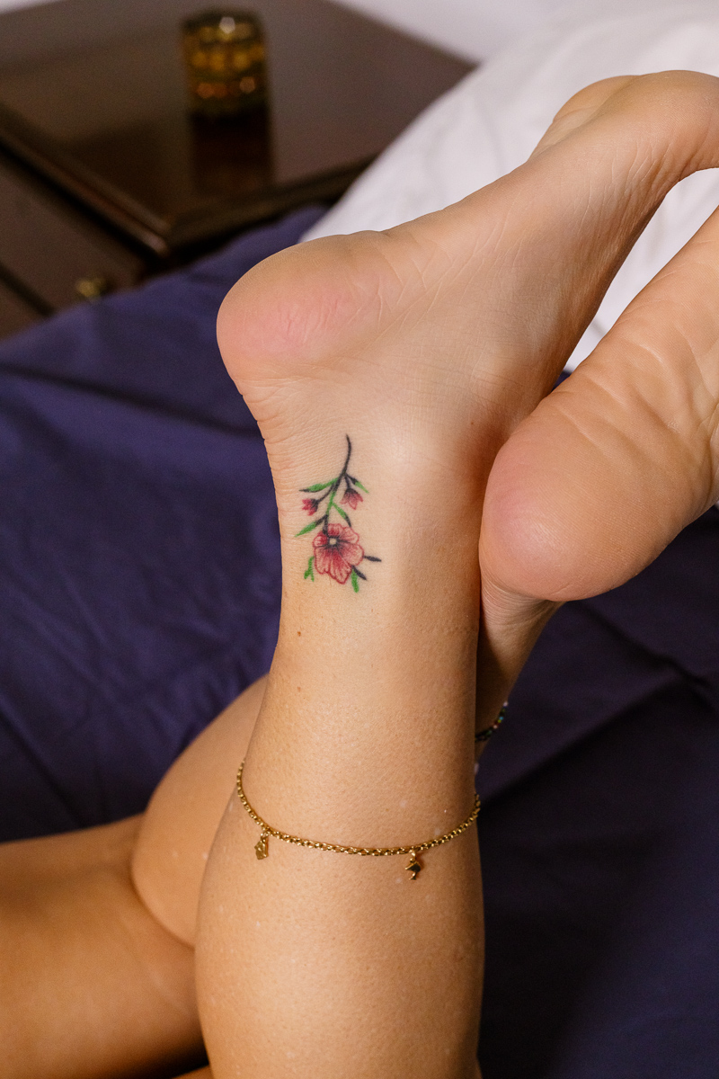 Claudia's ankle, with a beautifuil flower tattoo'